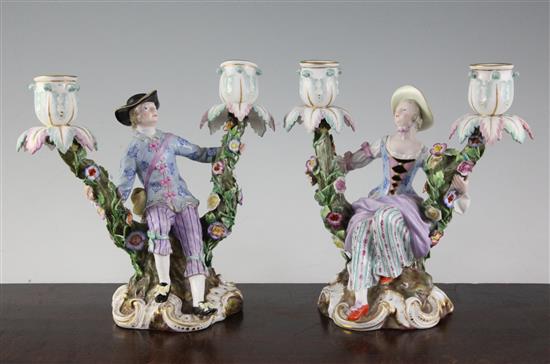 A pair of Meissen figural candelabra, late 19th century, height 19.5cm, typical minor losses to flowers, replacement nozzles